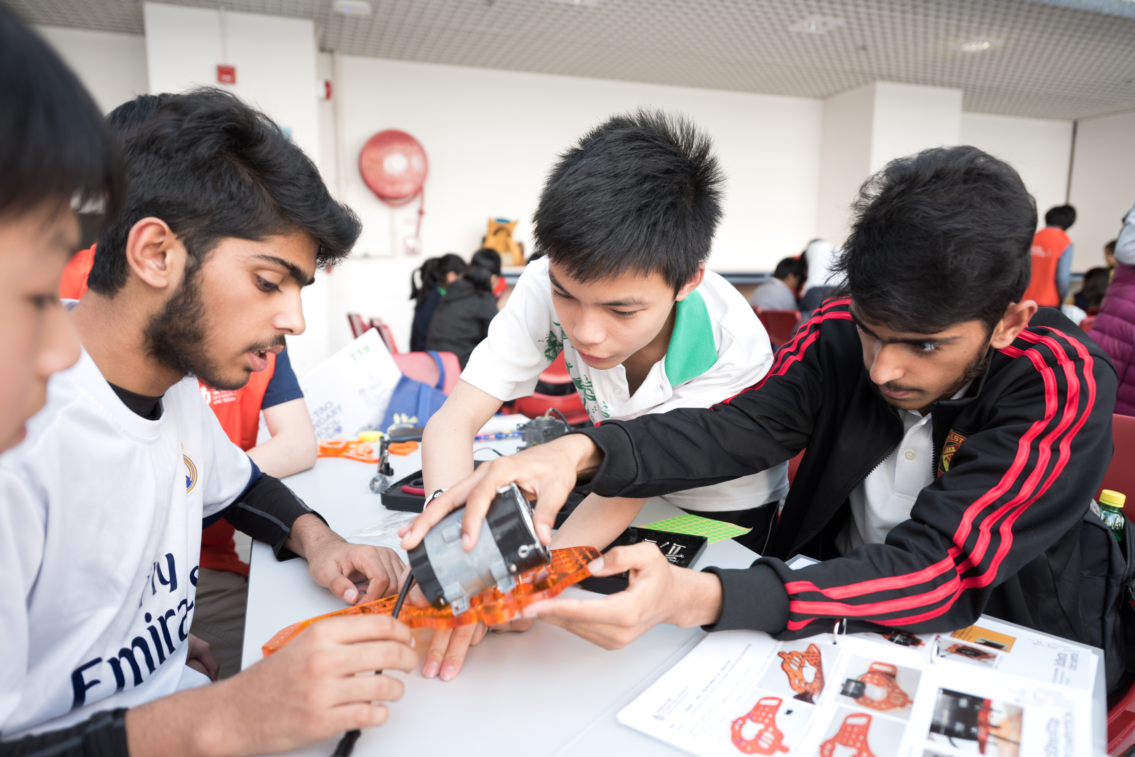  Students are getting some hands-on experience on robotics.