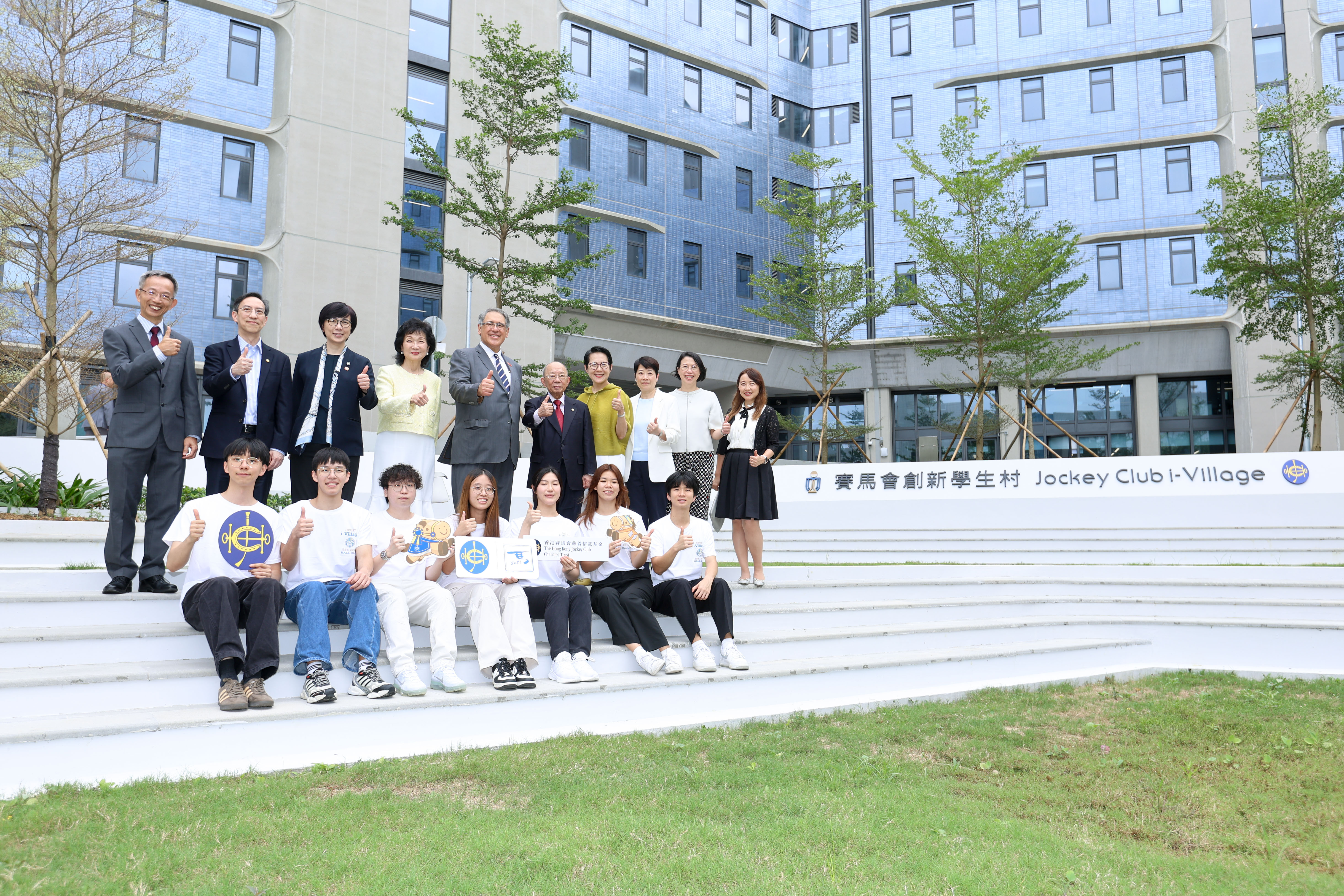Guests and students at the opening ceremony posed for a photo in front of the HKUST Jockey Club Innovation Student Village.